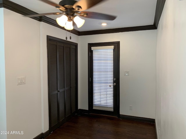 unfurnished room featuring dark hardwood / wood-style floors, ceiling fan, and ornamental molding