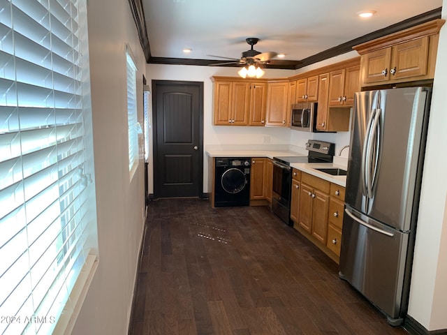 kitchen featuring appliances with stainless steel finishes, dark hardwood / wood-style floors, washer / clothes dryer, and ornamental molding