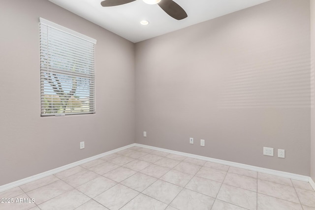 empty room featuring baseboards and ceiling fan