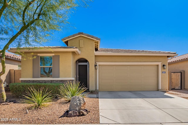 view of front of house with driveway, fence, a garage, a tile roof, and stucco siding
