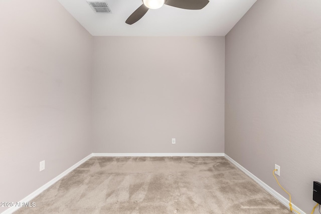 unfurnished room with carpet, baseboards, visible vents, and a ceiling fan