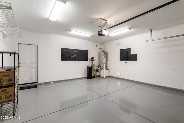 garage with water heater, baseboards, and a garage door opener