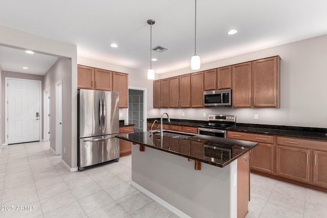 kitchen with a sink, visible vents, brown cabinets, and appliances with stainless steel finishes