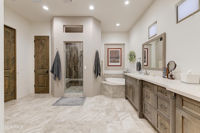 bathroom featuring vanity and separate shower and tub