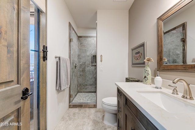 bathroom featuring vanity, toilet, and an enclosed shower