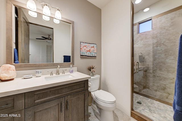 bathroom featuring vanity, ceiling fan, toilet, and walk in shower