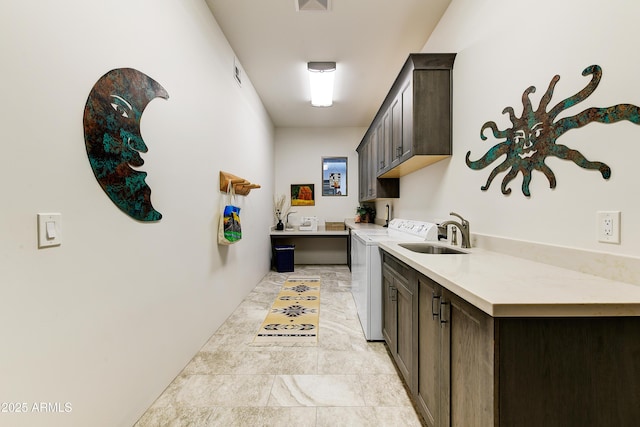 laundry room with cabinets, sink, and washing machine and dryer