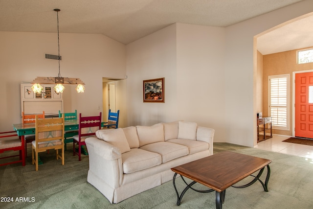 living room featuring a textured ceiling, carpet flooring, and high vaulted ceiling