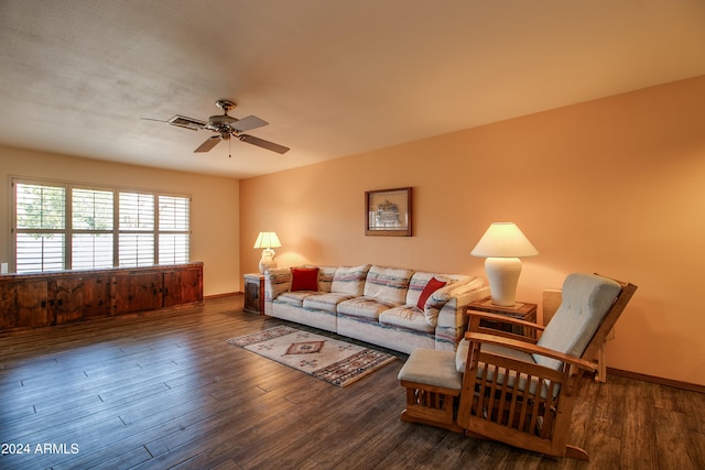 living room with ceiling fan and dark hardwood / wood-style floors