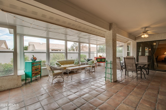 sunroom / solarium with a wealth of natural light and ceiling fan