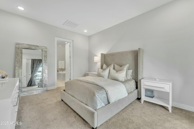 carpeted bedroom featuring ensuite bath