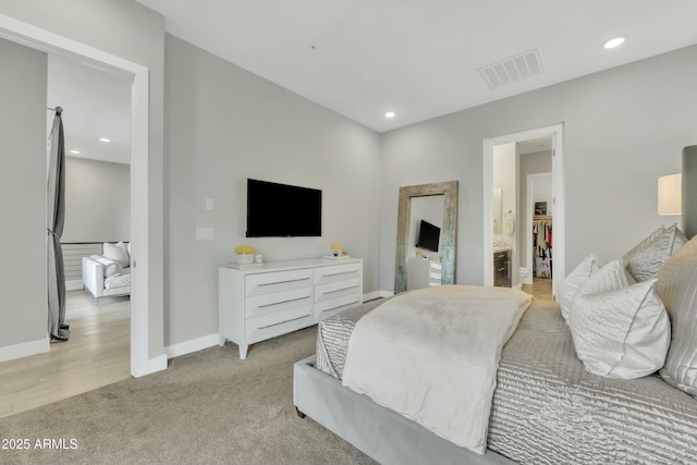 carpeted bedroom featuring ensuite bath