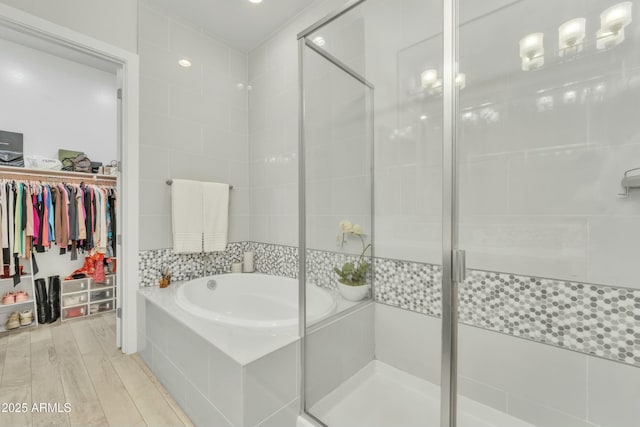 bathroom with wood-type flooring and plus walk in shower