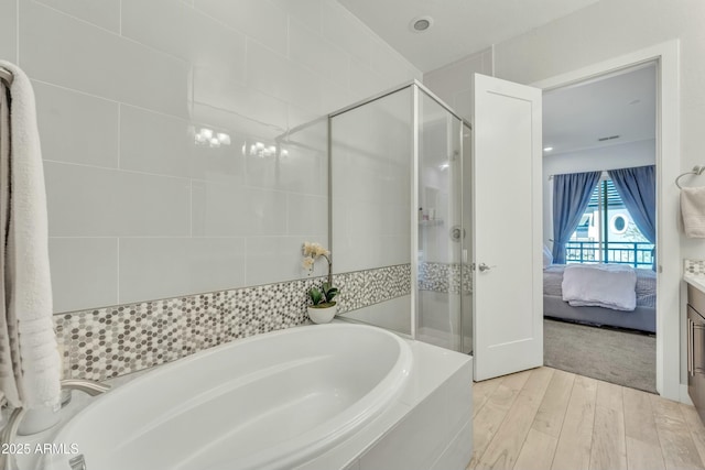 bathroom with vanity, separate shower and tub, and wood-type flooring