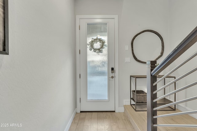 foyer entrance with light hardwood / wood-style floors