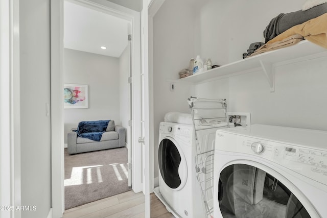 washroom featuring light hardwood / wood-style flooring and washing machine and clothes dryer