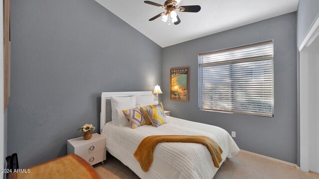 carpeted bedroom featuring ceiling fan, vaulted ceiling, and multiple windows