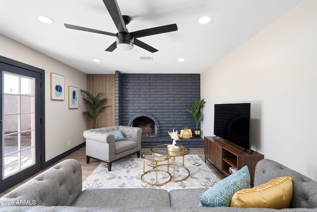 living area with a brick fireplace, wood finished floors, ceiling fan, recessed lighting, and baseboards