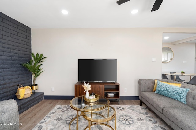 living area with a ceiling fan, wood finished floors, recessed lighting, and baseboards