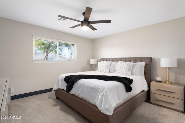 bedroom with light carpet, baseboards, and ceiling fan