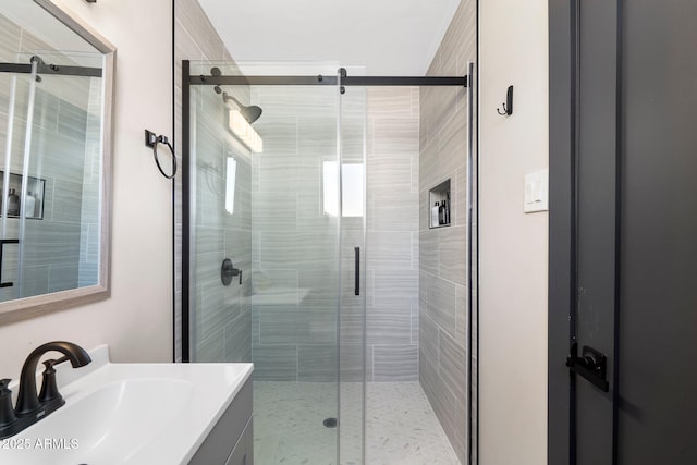 bathroom featuring vanity and a shower stall