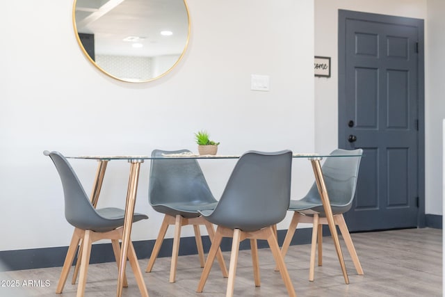 dining area with wood finished floors