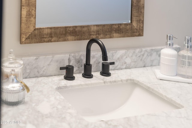 bathroom view of vanity and backsplash