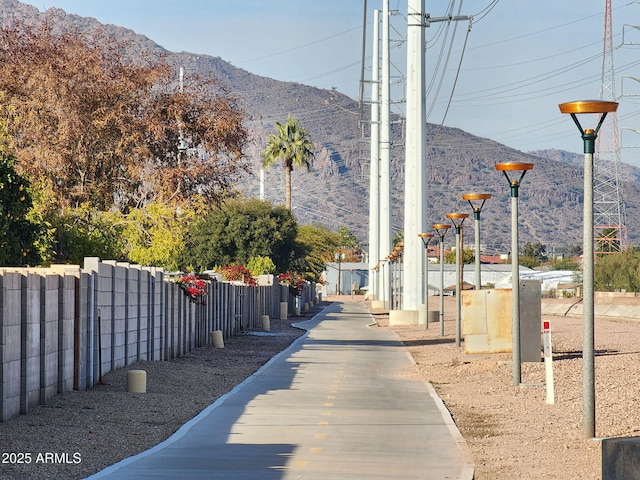 view of property's community with a mountain view and fence