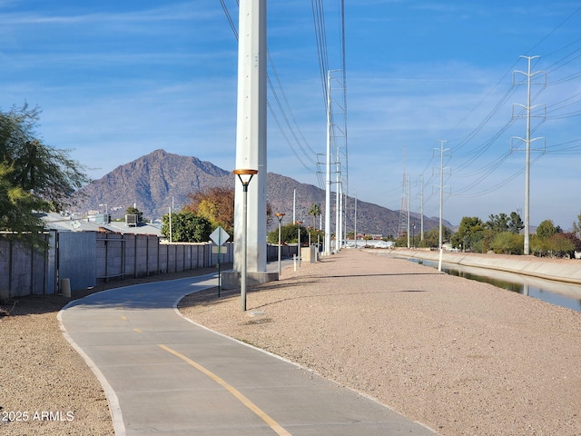view of street featuring a mountain view and traffic signs