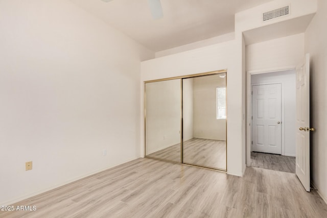 205 N 74th St Unit 110, Mesa, AZ 85207 - unfurnished bedroom with light wood-style floors, a closet, and a ceiling fan