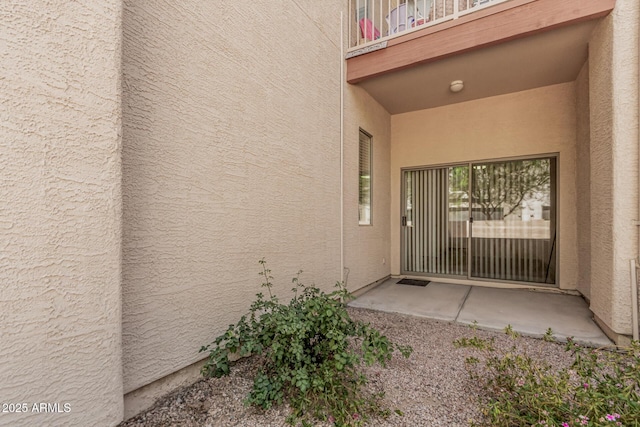 205 N 74th St Unit 110, Mesa, AZ 85207 - view of exterior entry with a balcony and stucco siding