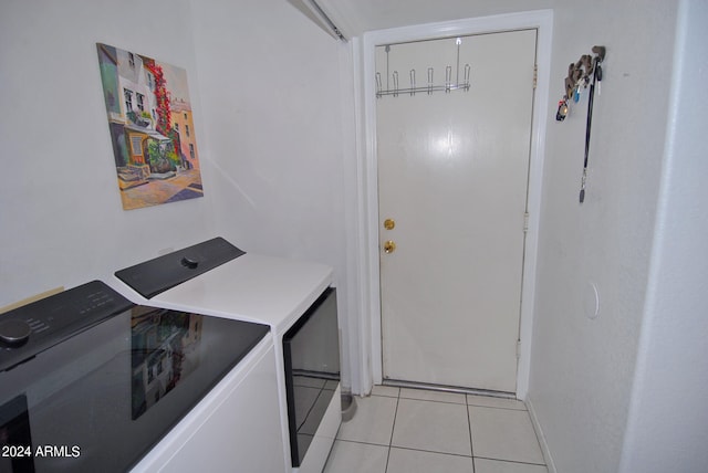 laundry area with light tile patterned floors and separate washer and dryer