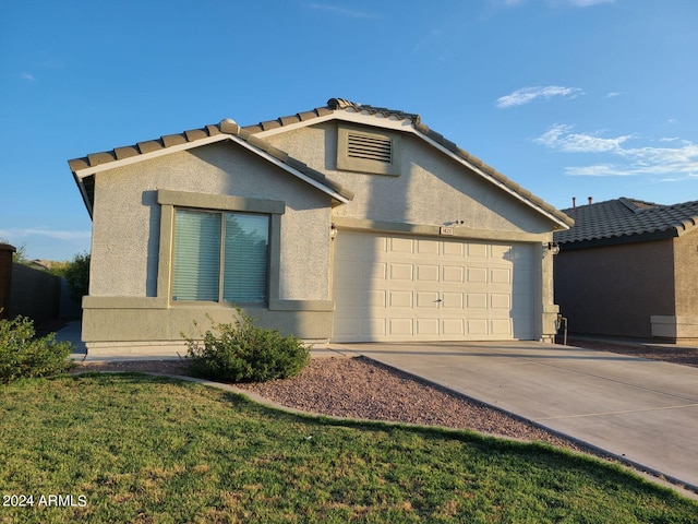 view of front of home with a garage and a front lawn