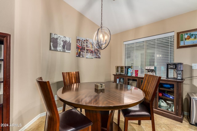 dining space featuring lofted ceiling, a chandelier, and light tile patterned floors