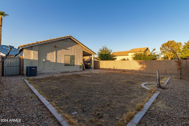 back of house with central AC unit