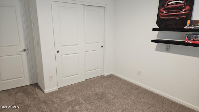 unfurnished bedroom featuring carpet floors and a closet