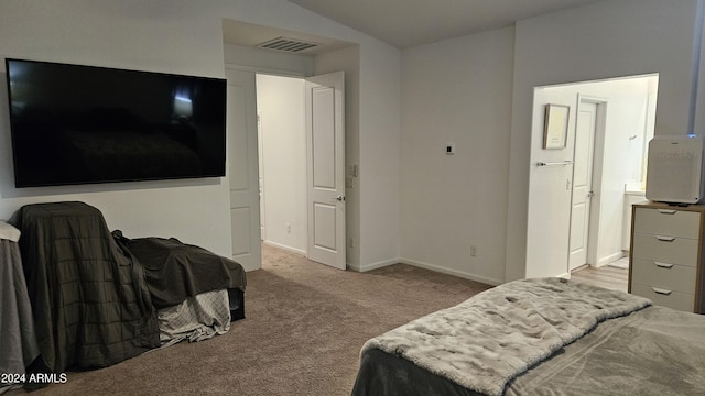 bedroom featuring light carpet and vaulted ceiling