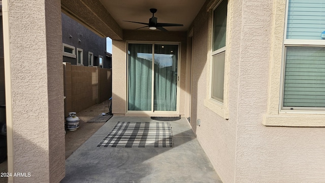 entrance to property with a patio area and ceiling fan