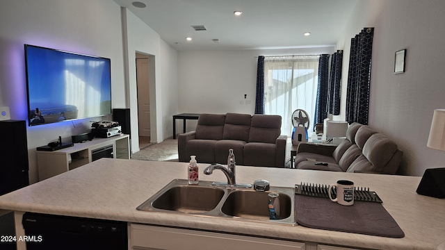 kitchen with sink, vaulted ceiling, and black dishwasher