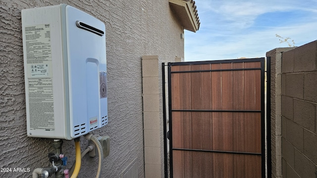 view of gate featuring water heater