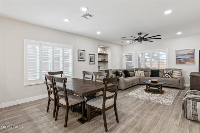 dining room with ceiling fan and light wood-type flooring