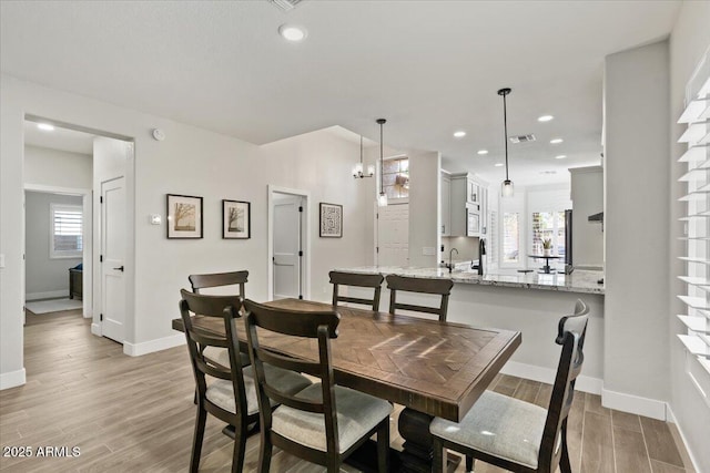 dining room with a healthy amount of sunlight and light hardwood / wood-style flooring