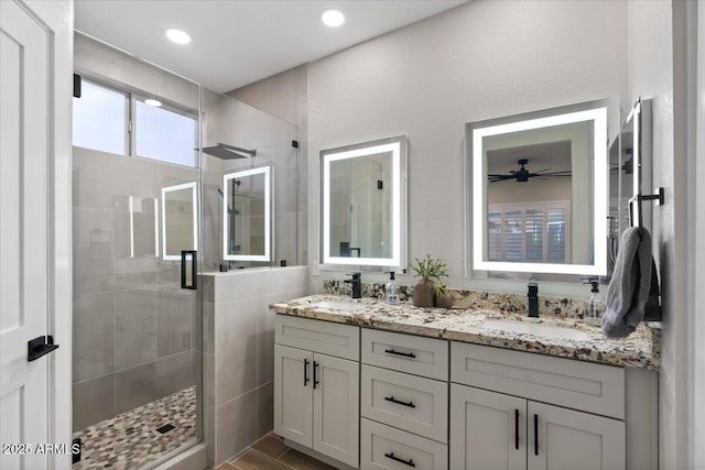 bathroom featuring walk in shower and vanity