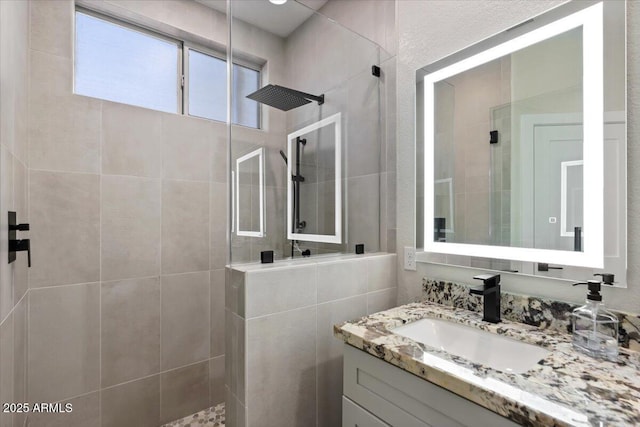 bathroom featuring vanity and a tile shower