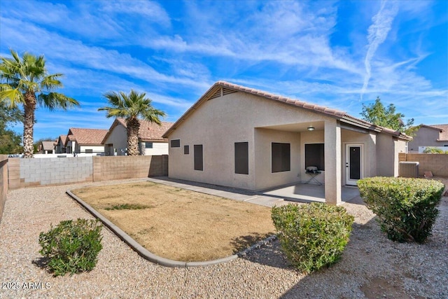 back of property with a patio area and central air condition unit