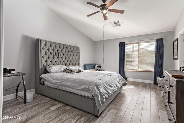 bedroom featuring hardwood / wood-style flooring, ceiling fan, and lofted ceiling