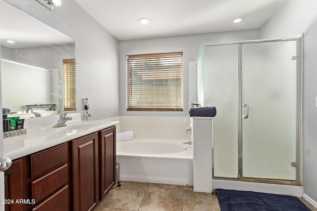 bathroom with plus walk in shower, vanity, and tile patterned flooring