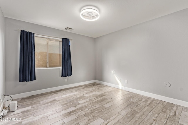 empty room with light hardwood / wood-style flooring