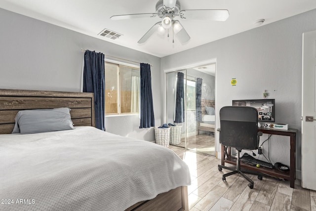 bedroom featuring a closet, light hardwood / wood-style flooring, and ceiling fan