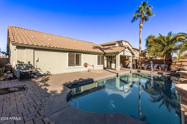 view of pool with a patio area and central air condition unit